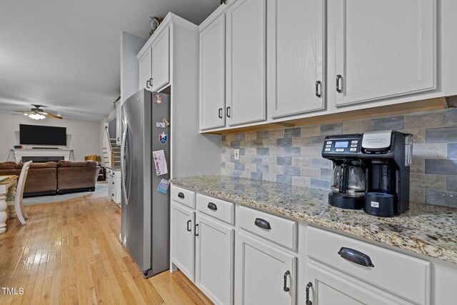 15 Smoketree Ct, Durham, NC 27712 - kitchen with freestanding refrigerator, white cabinets, a ceiling fan, open floor plan, and decorative backsplash