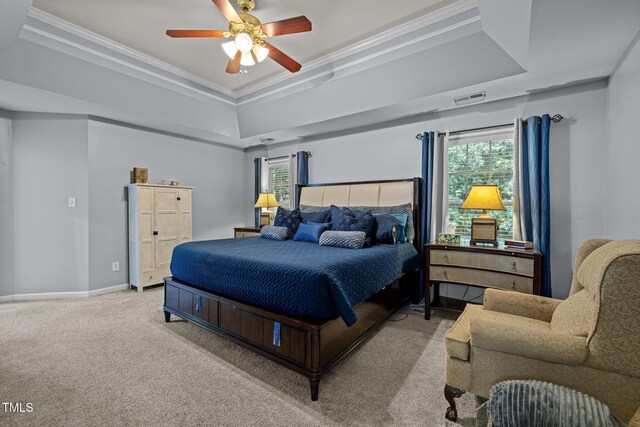 15 Smoketree Ct, Durham, NC 27712 - carpeted bedroom featuring a tray ceiling, ornamental molding, multiple windows, and ceiling fan