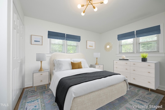2320 Marks Creek Rd, Knightdale, NC 27545 - bedroom with multiple windows, a chandelier, dark wood finished floors, and a closet