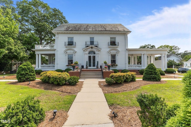 309 W Divine St, Dunn, NC 28334 - view of front of home featuring a balcony, french doors, and a front lawn