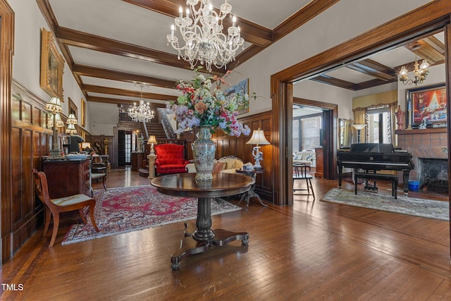 309 W Divine St, Dunn, NC 28334 - living area with a chandelier, beamed ceiling, wood-type flooring, crown molding, and a wainscoted wall