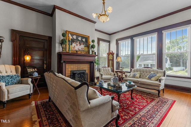 309 W Divine St, Dunn, NC 28334 - living area featuring hardwood / wood-style flooring, a chandelier, a tiled fireplace, and ornamental molding