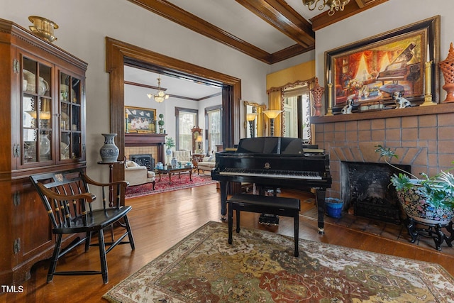 309 W Divine St, Dunn, NC 28334 - sitting room with a tiled fireplace, crown molding, wood finished floors, beamed ceiling, and a chandelier