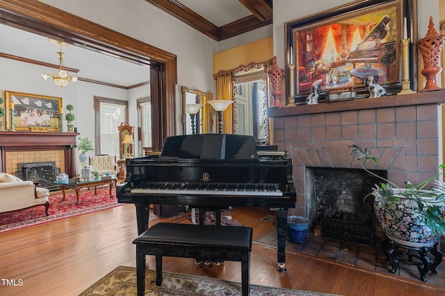 309 W Divine St, Dunn, NC 28334 - living area with a tiled fireplace, ornamental molding, wood finished floors, beamed ceiling, and a chandelier