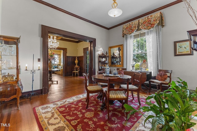 309 W Divine St, Dunn, NC 28334 - dining area with ornamental molding, hardwood / wood-style flooring, and a chandelier
