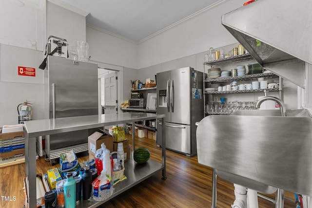 309 W Divine St, Dunn, NC 28334 - kitchen with stainless steel refrigerator with ice dispenser, ornamental molding, wood finished floors, freestanding refrigerator, and stainless steel counters