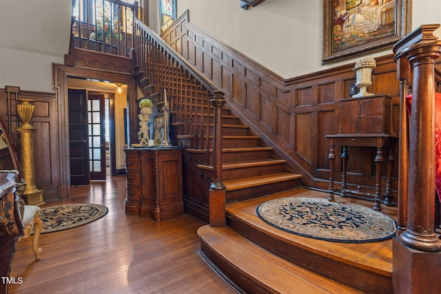 309 W Divine St, Dunn, NC 28334 - stairway featuring wood finished floors, a high ceiling, and wood walls