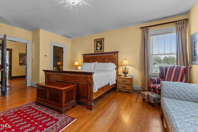 309 W Divine St, Dunn, NC 28334 - bedroom with light wood finished floors and baseboards