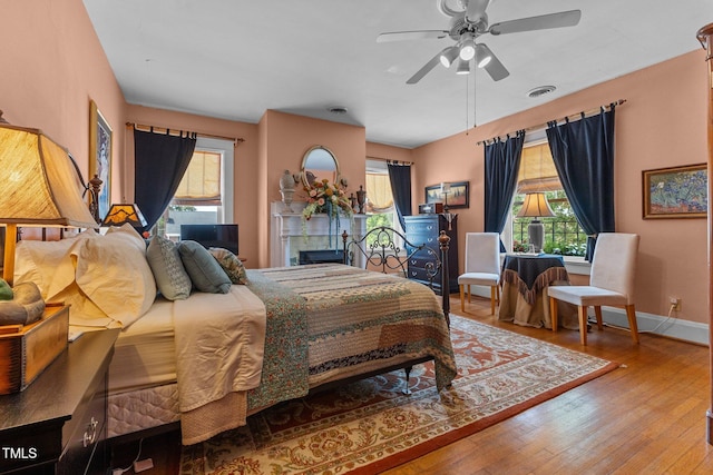 309 W Divine St, Dunn, NC 28334 - bedroom with multiple windows, wood finished floors, and ceiling fan