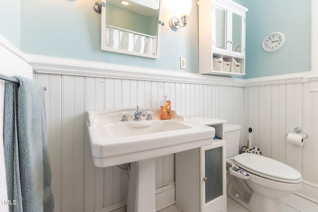 309 W Divine St, Dunn, NC 28334 - bathroom with a wainscoted wall and a decorative wall