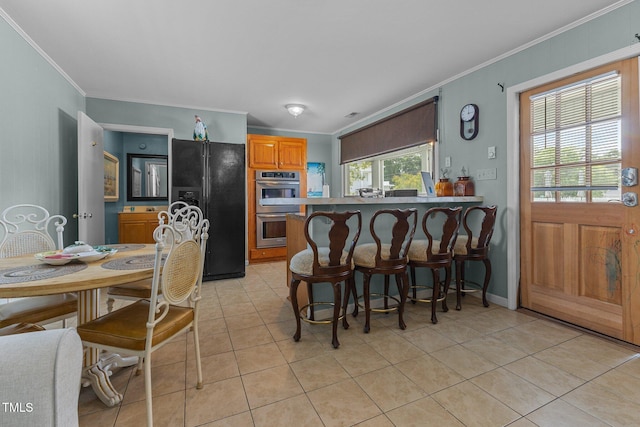 309 W Divine St, Dunn, NC 28334 - kitchen with black refrigerator with ice dispenser, double oven, light tile patterned floors, crown molding, and a peninsula