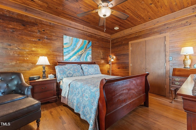 309 W Divine St, Dunn, NC 28334 - bedroom with wooden walls, wood ceiling, wood finished floors, and ceiling fan