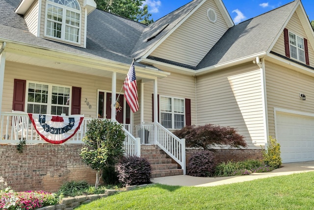 200 Holly Branch Dr, Holly Springs, NC 27540 - view of front facade featuring an attached garage, covered porch, and a shingled roof
