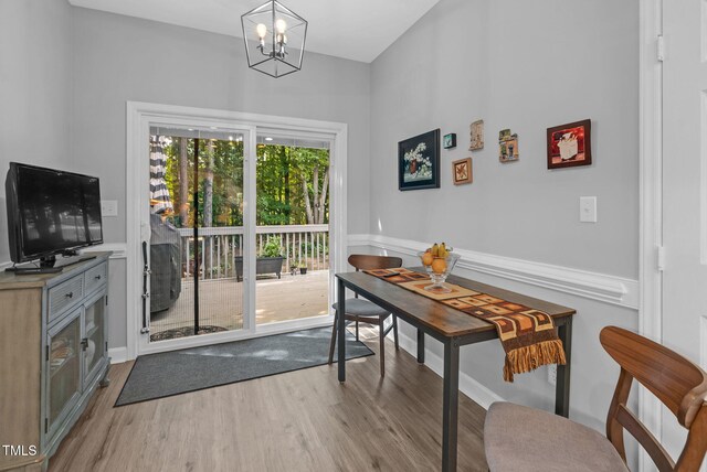 200 Holly Branch Dr, Holly Springs, NC 27540 - dining area with wood finished floors, a chandelier, and wainscoting