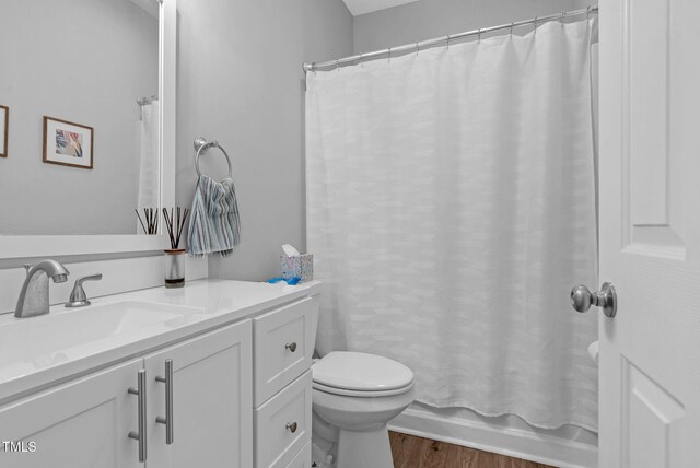 200 Holly Branch Dr, Holly Springs, NC 27540 - bathroom with vanity, wood finished floors, and shower / bath combo with shower curtain