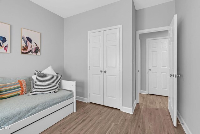200 Holly Branch Dr, Holly Springs, NC 27540 - bedroom featuring light wood-style floors and a closet