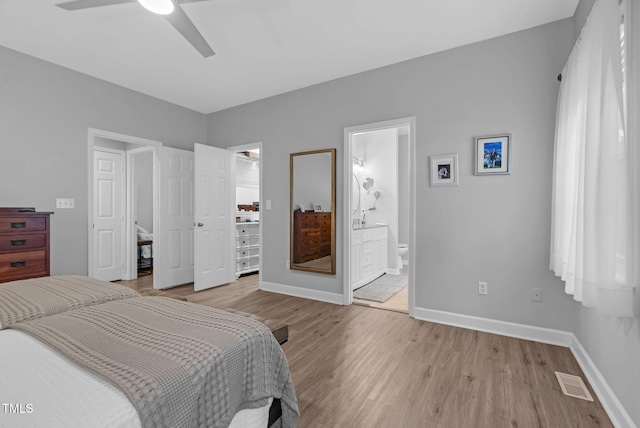 200 Holly Branch Dr, Holly Springs, NC 27540 - bedroom featuring a spacious closet, light wood finished floors, connected bathroom, a closet, and a ceiling fan