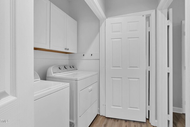 200 Holly Branch Dr, Holly Springs, NC 27540 - laundry area featuring cabinet space, washer and clothes dryer, and light wood-style flooring