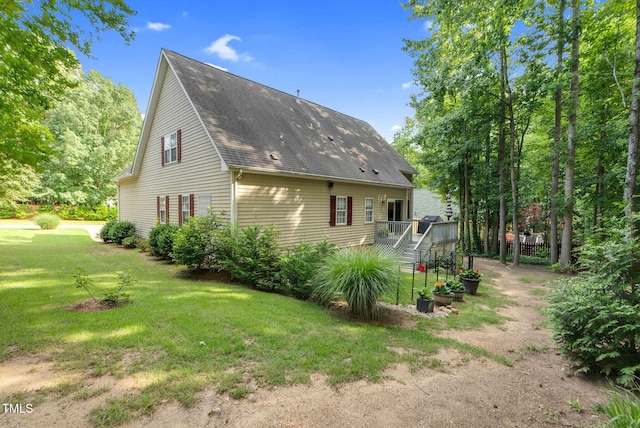200 Holly Branch Dr, Holly Springs, NC 27540 - back of property with a lawn and a shingled roof