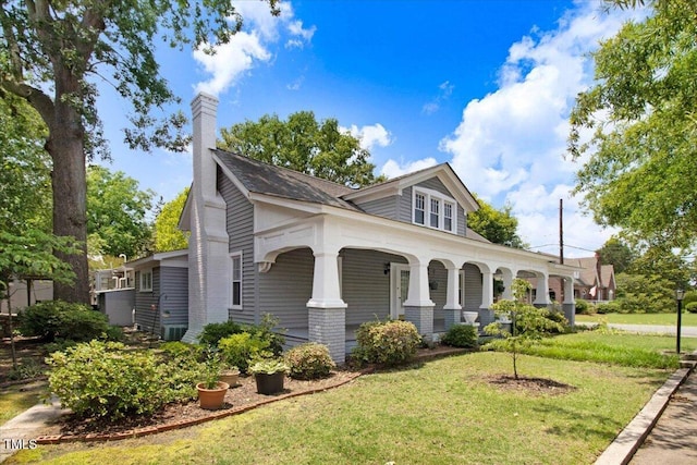 125 W Pine St, Pine Level, NC 27568 - view of front of home featuring covered porch, a front lawn, and a chimney
