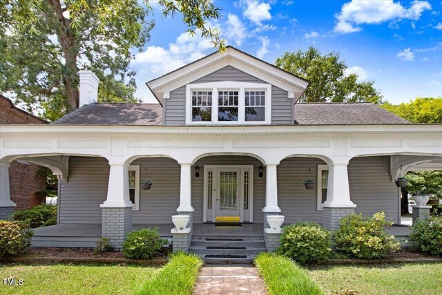 125 W Pine St, Pine Level, NC 27568 - view of front of property with covered porch, a chimney, and roof with shingles