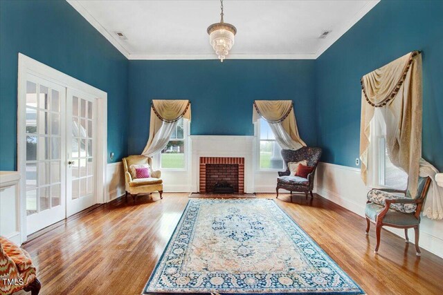 125 W Pine St, Pine Level, NC 27568 - sitting room with french doors, wood finished floors, crown molding, a brick fireplace, and baseboards
