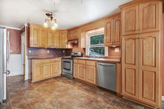 125 W Pine St, Pine Level, NC 27568 - kitchen featuring appliances with stainless steel finishes, a sink, under cabinet range hood, wainscoting, and a chandelier