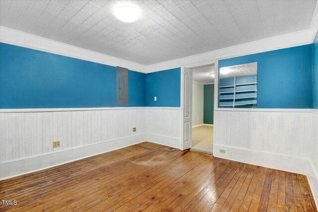 125 W Pine St, Pine Level, NC 27568 - spare room with wainscoting and wood-type flooring