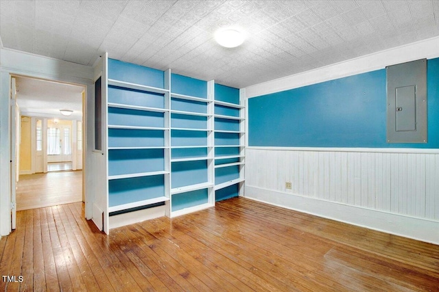 125 W Pine St, Pine Level, NC 27568 - unfurnished room with electric panel, wood-type flooring, built in features, wainscoting, and baseboards