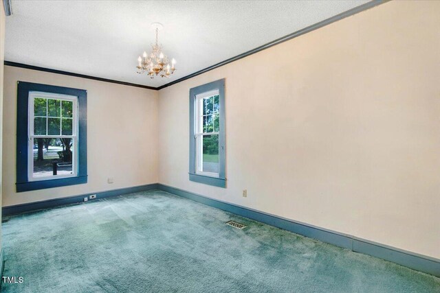 125 W Pine St, Pine Level, NC 27568 - carpeted spare room with ornamental molding, a chandelier, baseboards, plenty of natural light, and a textured ceiling