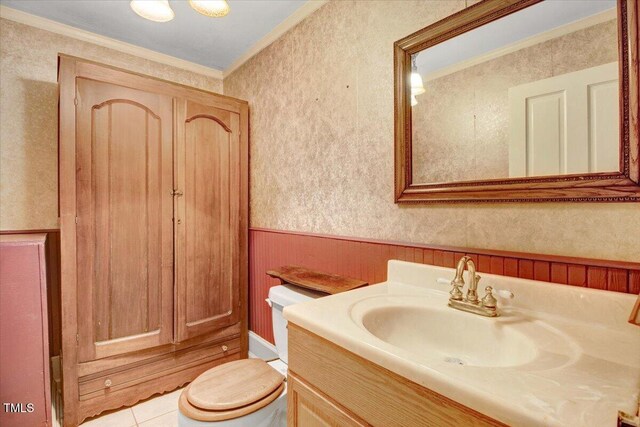 125 W Pine St, Pine Level, NC 27568 - bathroom with crown molding, toilet, vanity, wainscoting, and tile patterned flooring