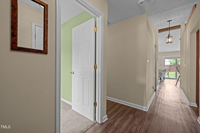 5801 Hadrian Dr, Durham, NC 27703 - hallway with wood finished floors and a textured ceiling