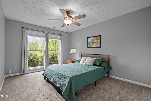 5801 Hadrian Dr, Durham, NC 27703 - carpeted bedroom featuring a textured ceiling and ceiling fan