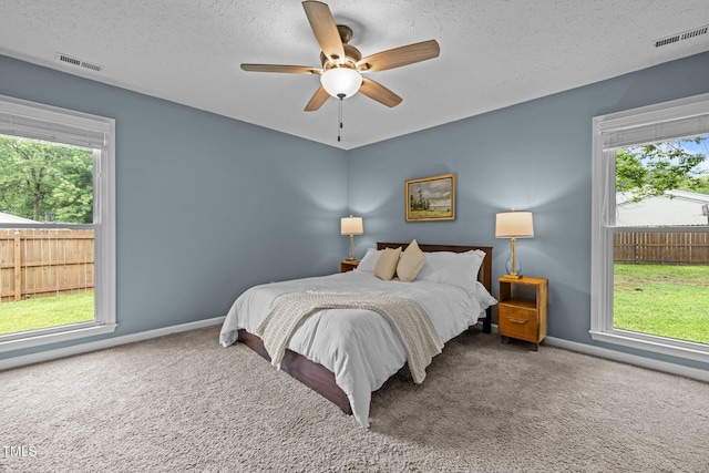 5801 Hadrian Dr, Durham, NC 27703 - bedroom with carpet floors, a textured ceiling, and ceiling fan