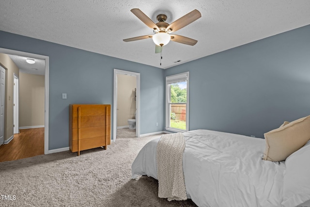 5801 Hadrian Dr, Durham, NC 27703 - bedroom with carpet, a textured ceiling, a ceiling fan, and ensuite bathroom