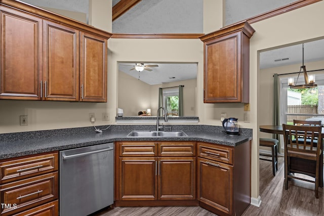 5801 Hadrian Dr, Durham, NC 27703 - kitchen featuring dishwasher, dark countertops, wood finished floors, vaulted ceiling, and brown cabinetry