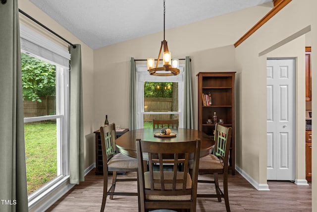 5801 Hadrian Dr, Durham, NC 27703 - dining space featuring lofted ceiling, wood finished floors, and a chandelier