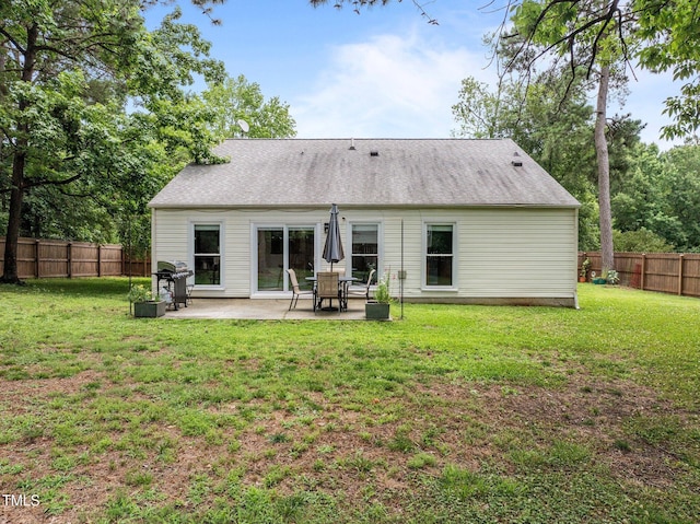 5801 Hadrian Dr, Durham, NC 27703 - rear view of house featuring a patio and a fenced backyard