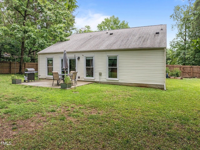 5801 Hadrian Dr, Durham, NC 27703 - rear view of property with a patio, a fenced backyard, and roof with shingles