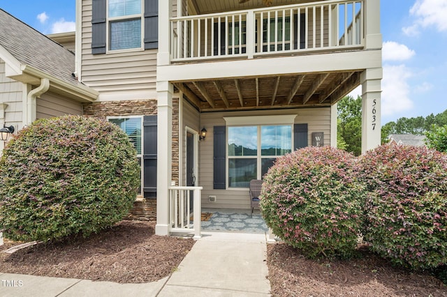 5637 Garnet Meadow Rd, Knightdale, NC 27545 - view of exterior entry featuring a balcony and a shingled roof
