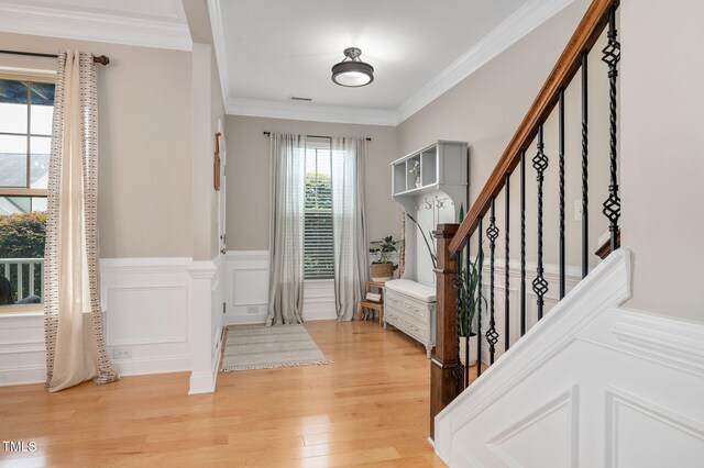 5637 Garnet Meadow Rd, Knightdale, NC 27545 - entryway with light wood-type flooring, crown molding, stairs, and a wainscoted wall