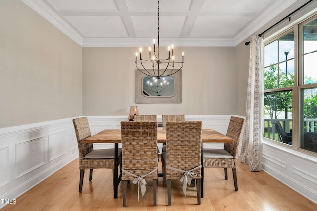5637 Garnet Meadow Rd, Knightdale, NC 27545 - dining area with a chandelier, coffered ceiling, light wood-style floors, a decorative wall, and ornamental molding
