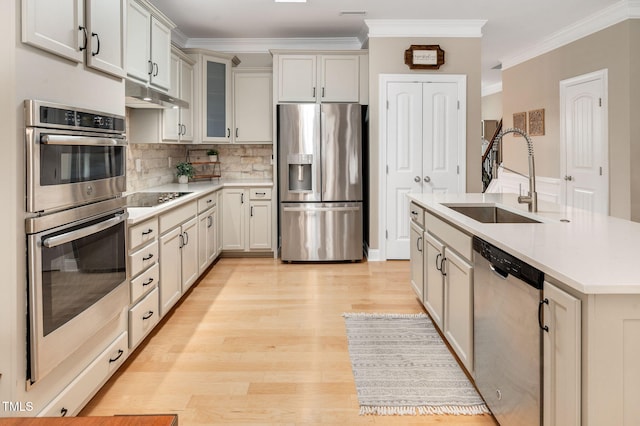 5637 Garnet Meadow Rd, Knightdale, NC 27545 - kitchen featuring stainless steel appliances, under cabinet range hood, light countertops, tasteful backsplash, and crown molding