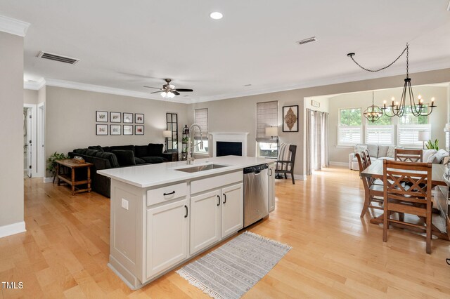 5637 Garnet Meadow Rd, Knightdale, NC 27545 - kitchen featuring stainless steel dishwasher, open floor plan, a chandelier, a ceiling fan, and crown molding