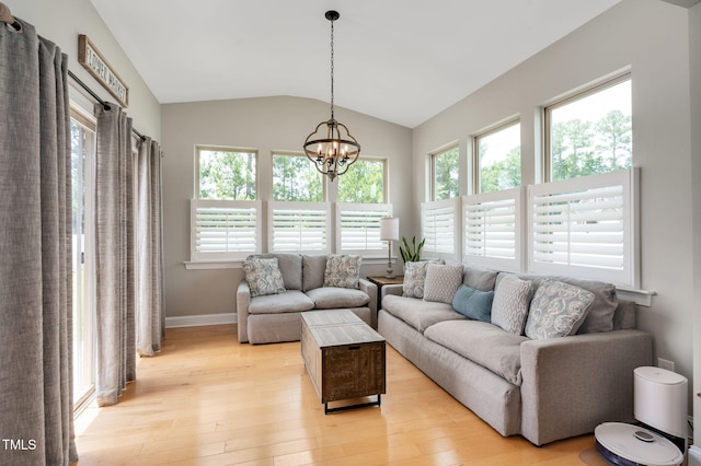 5637 Garnet Meadow Rd, Knightdale, NC 27545 - living area with plenty of natural light, light wood finished floors, vaulted ceiling, and a chandelier