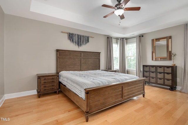 5637 Garnet Meadow Rd, Knightdale, NC 27545 - bedroom featuring a raised ceiling, light wood-style flooring, and ceiling fan