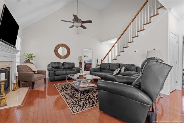 60 Rolling Pines Dr, Spring Lake, NC 28390 - living area featuring stairs, wood-type flooring, ceiling fan, a premium fireplace, and high vaulted ceiling