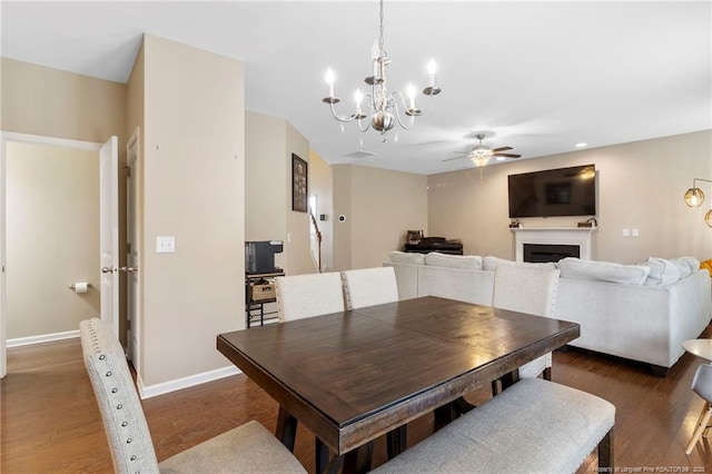 18 Hallow Oak St, Spring Lake, NC 28390 - dining area with ceiling fan, a chandelier, a fireplace, wood finished floors, and baseboards
