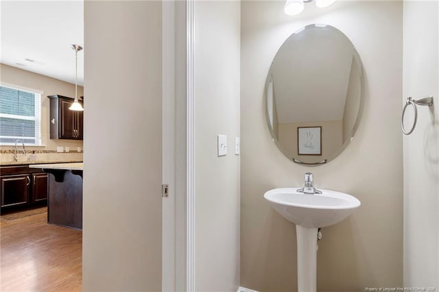 18 Hallow Oak St, Spring Lake, NC 28390 - bathroom featuring a sink, wood finished floors, and tasteful backsplash