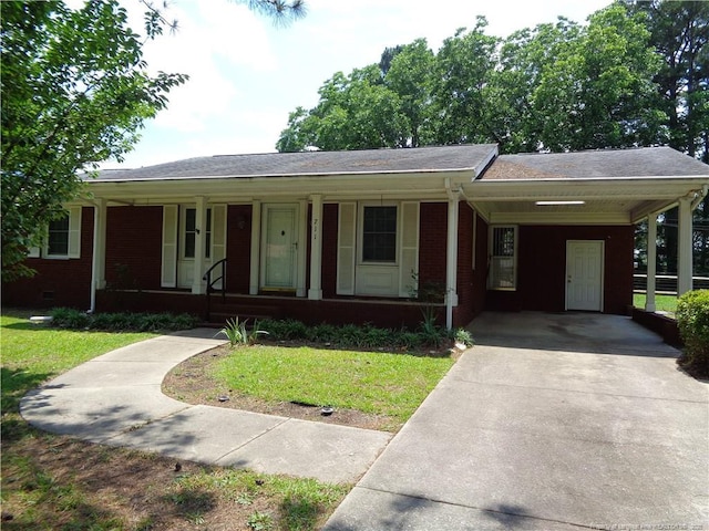 711 Fairview St, Fayetteville, NC 28312 - ranch-style home featuring concrete driveway, covered porch, brick siding, an attached carport, and a front yard
